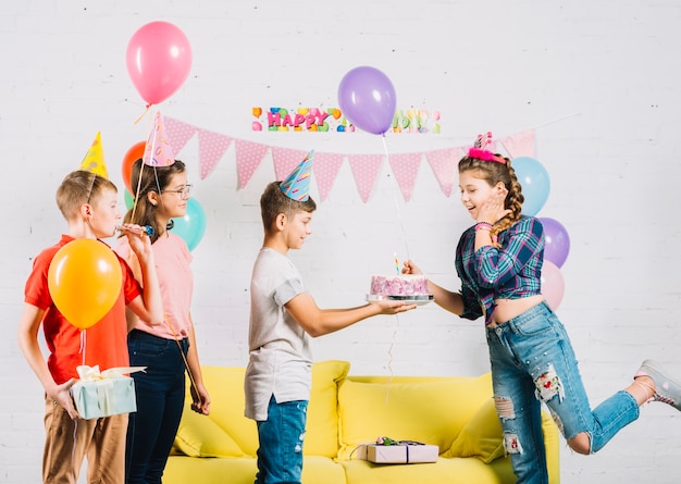 Free photo friends celebrating girl's birthday with cake