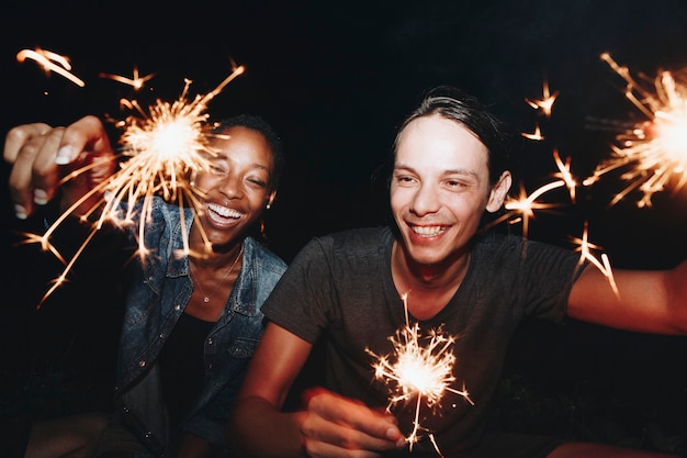 Friends celebrating with sparklers in the night