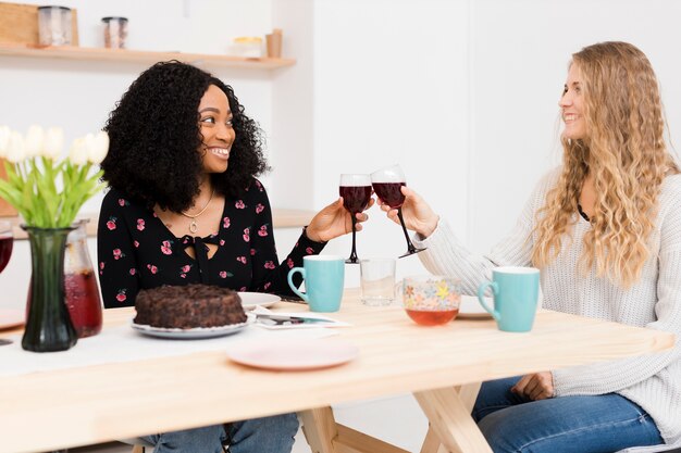 Friends cheering with a glass of wine