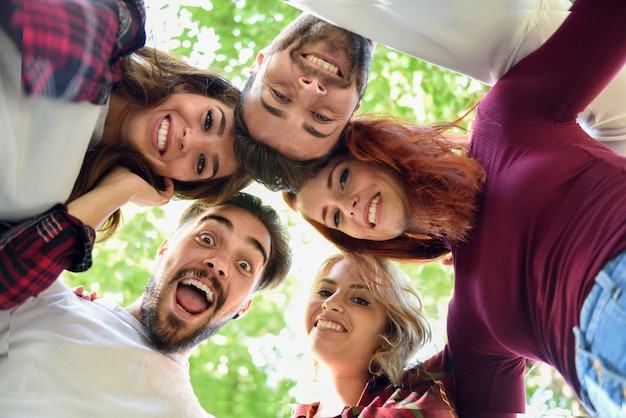 Free Photo friends in circle with heads together smiling