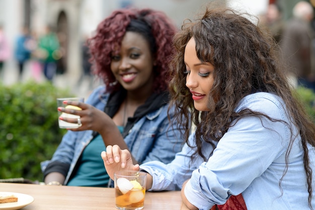 Friends drinking iced tea and laughing