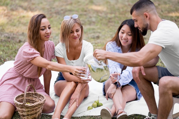 Friends drinking lemonade together outside