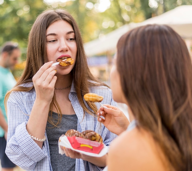 Friends eating at the amusement park