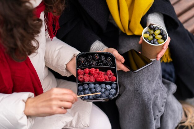 Friends eating berries high angle