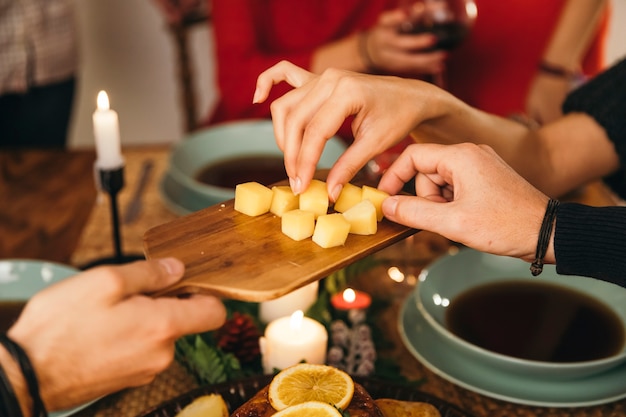 Free photo friends eating cheese at christmas