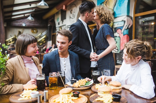 Friends eating and conversating in restaurant