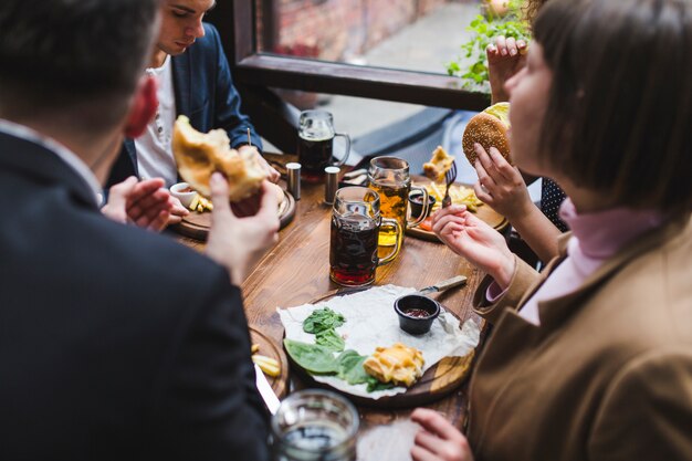 Friends eating and conversating in restaurant