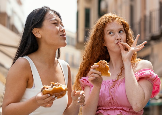 Free photo friends eating together some street food