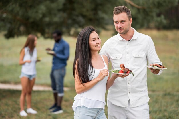 Friends enjoying barbecue outdoors