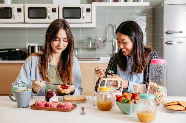 Friends enjoying breakfast in kitchen