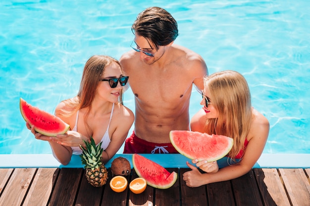 Friends enjoying a fresh watermelon