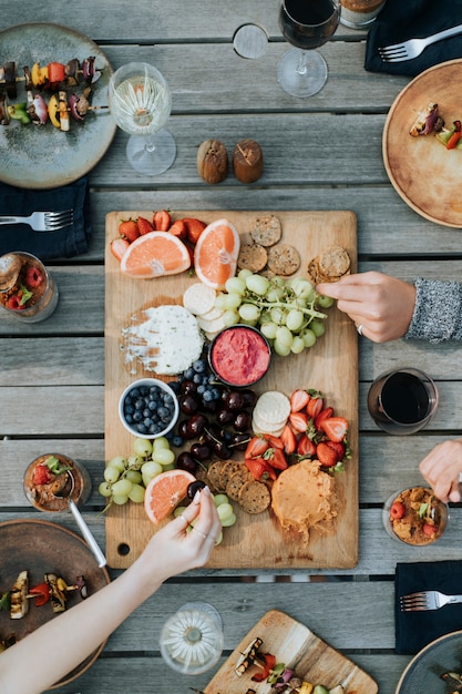 Free Photo friends enjoying a fruit platter