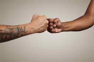 Free photo friends do a fist bump close up isolated on white