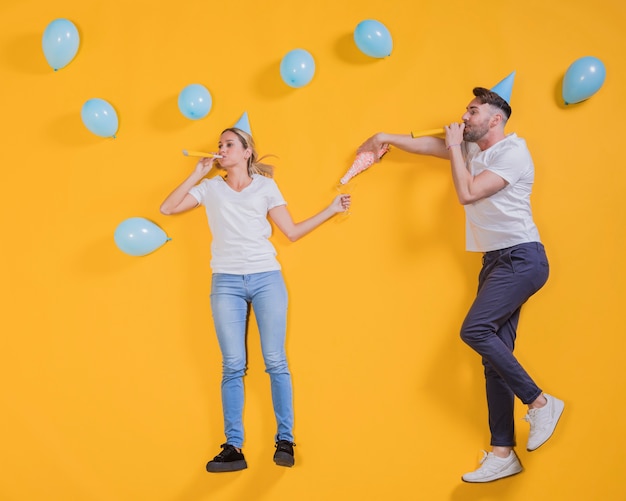 Free photo friends floating with blue balloons