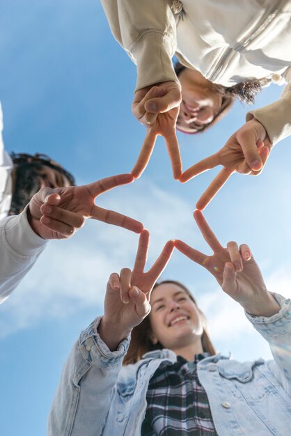 Friends forming star shape with fingers