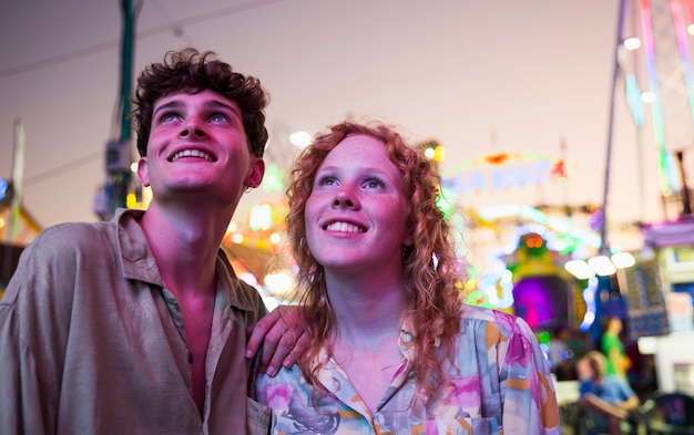 Friends at funfair looking away 