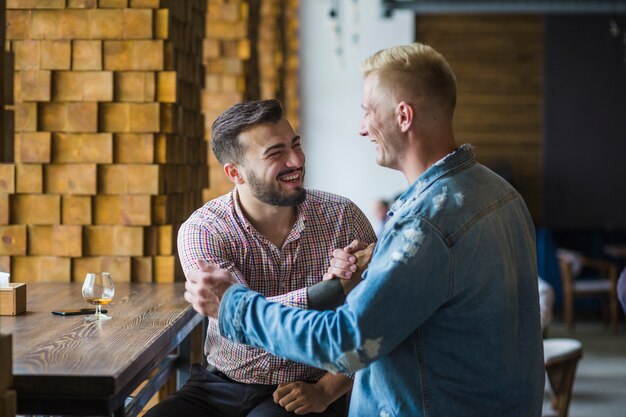 Friends greeting each other with hand shake