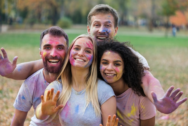 Friends happily posing at holi festival