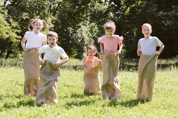 Friends having a contest with burlap bags