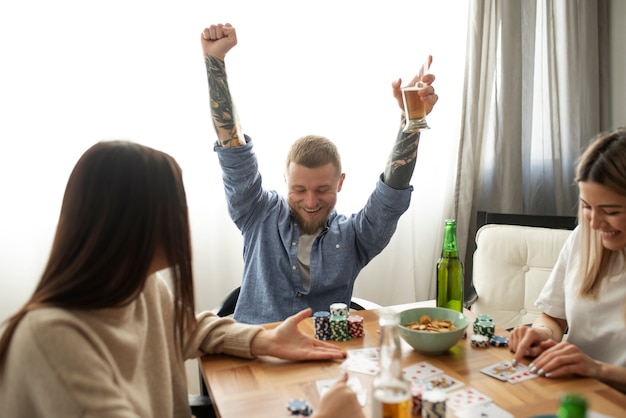 Free photo friends having fun while playing poker