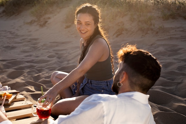 Friends having a sangria party by the beach