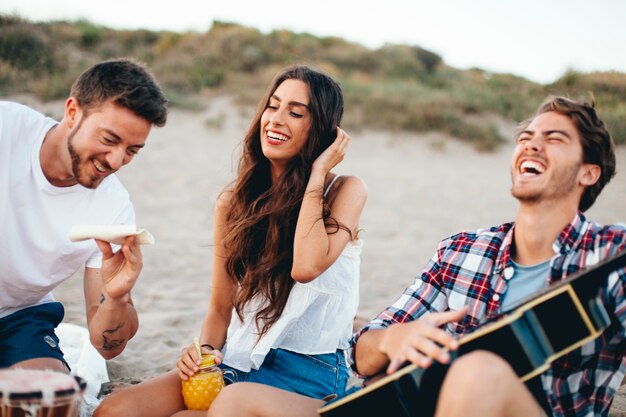 Friends laughing together at the beach