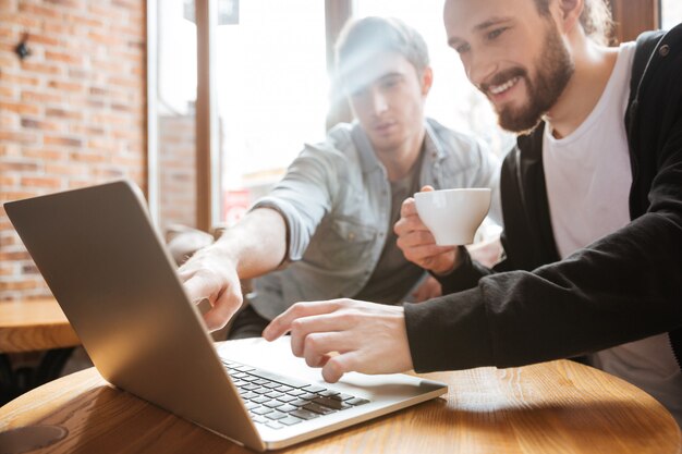 Friends looking in laptop