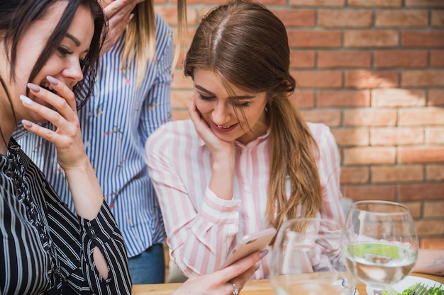 Friends looking at phone screen