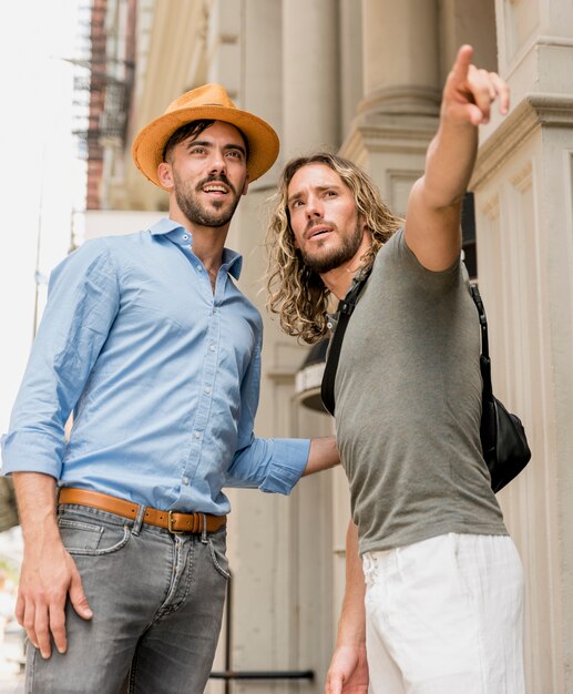 Friends looking at pointed touristic attraction