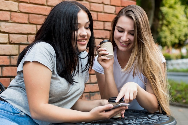 Friends looking at something fun on a smart phone