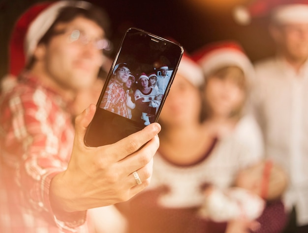 Free Photo friends making selfie in santa hats