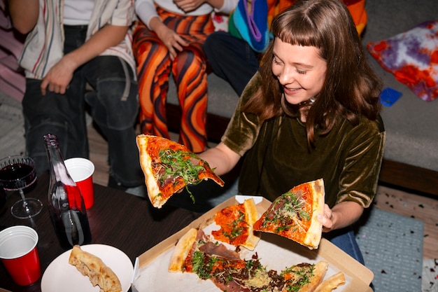 Free photo friends at party with delicious pizza