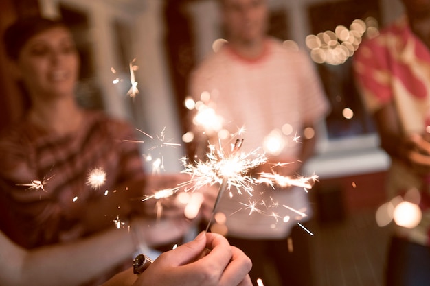 Free Photo friends partying with fireworks high angle