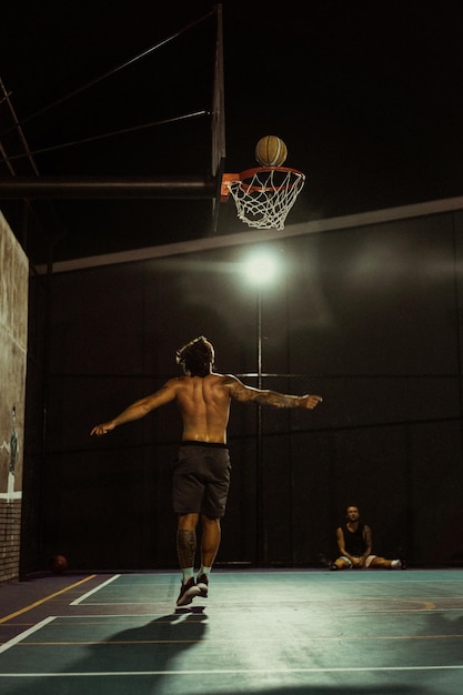 Friends play basketball. Young men play basketball in the street.