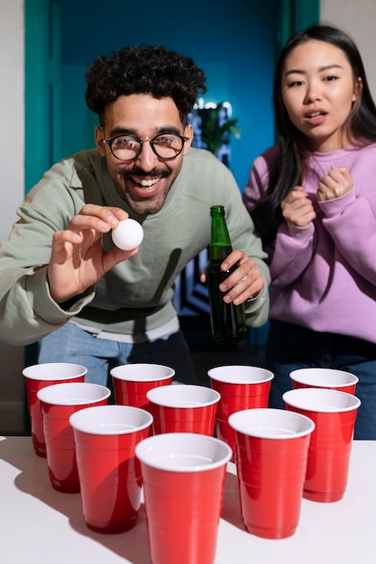 Friends playing beer pong