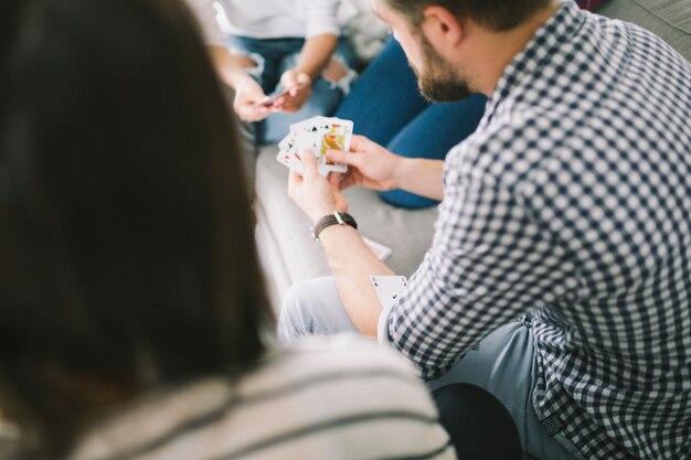 Friends playing cards on party