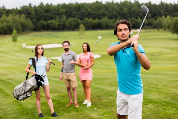 Free photo friends playing golf on field