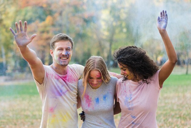 Friends playing with colored paint at holi