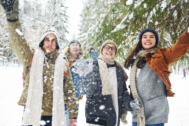 Free photo friends playing with snow on vacation