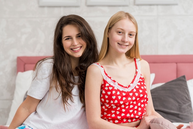 Free Photo friends posing on the bed