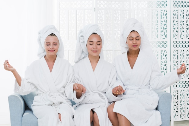 Friends posing with bathrobe in a spa