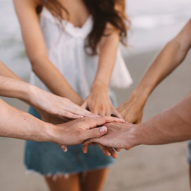 Friends putting hands together