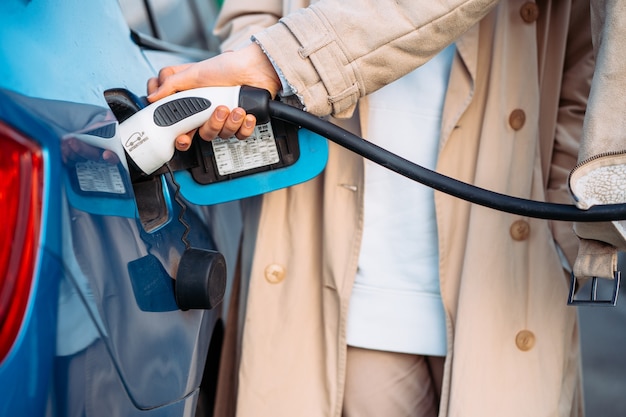 Free photo friends refuel car in gas station.