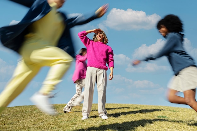 Friends running around together on a field outdoors