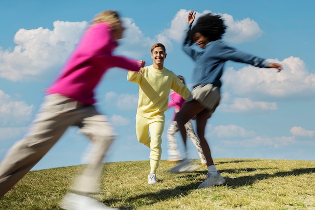 Free photo friends running around together on a field outdoors