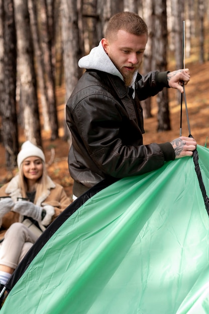 Free Photo friends setting their winter camping tent