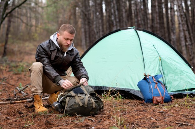 Friends setting their winter camping tent