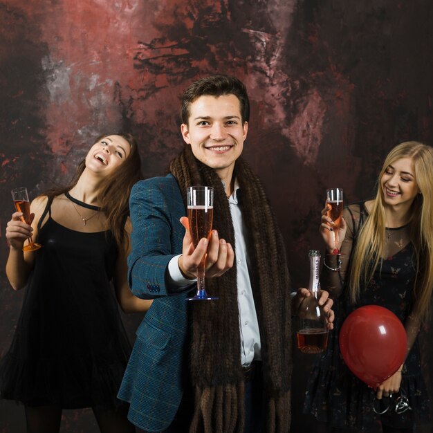 Friends showing champagne glasses