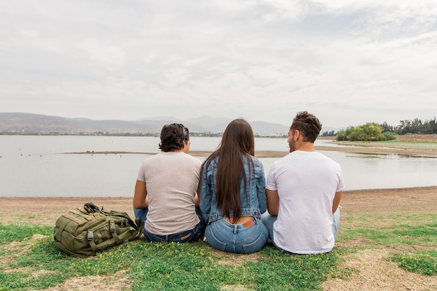 Friends sitting at seaside