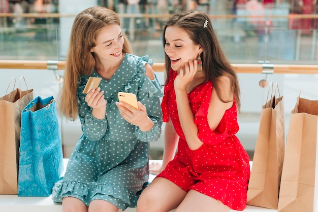 Friends sitting and talking at the shopping center 